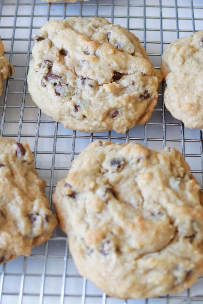 The best chewy chocolate chip cookies ever on a wire rack.