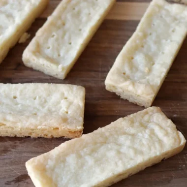 Shortbread cookies on a wooden cutting board.