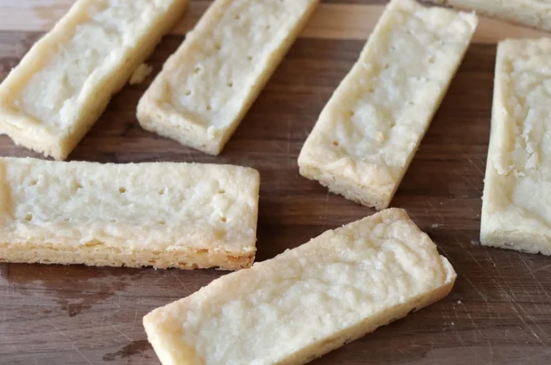 Shortbread cookies on a wooden cutting board.