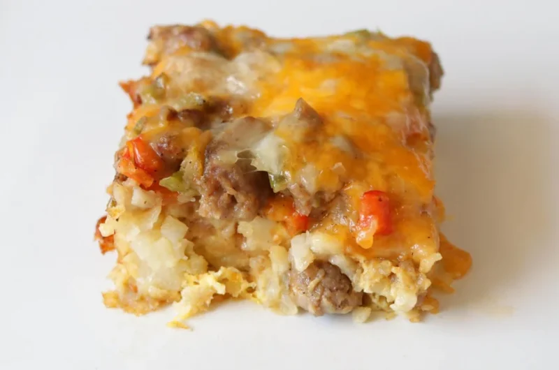 Slice of tater tot breakfast casserole on a white plate