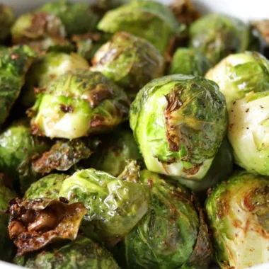 Large white bowl filled with air fryer Brussels sprouts