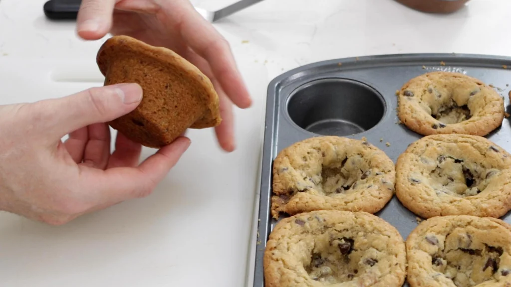 Nutella stuffed cookie cup in hands.