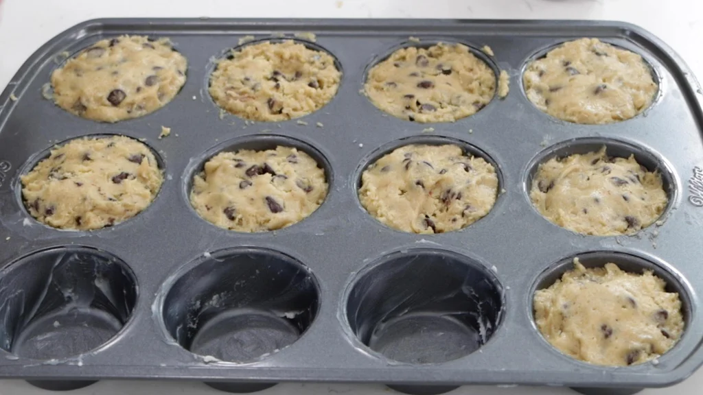 Homemade Nutella stuffed cookie cups ready to be baked.