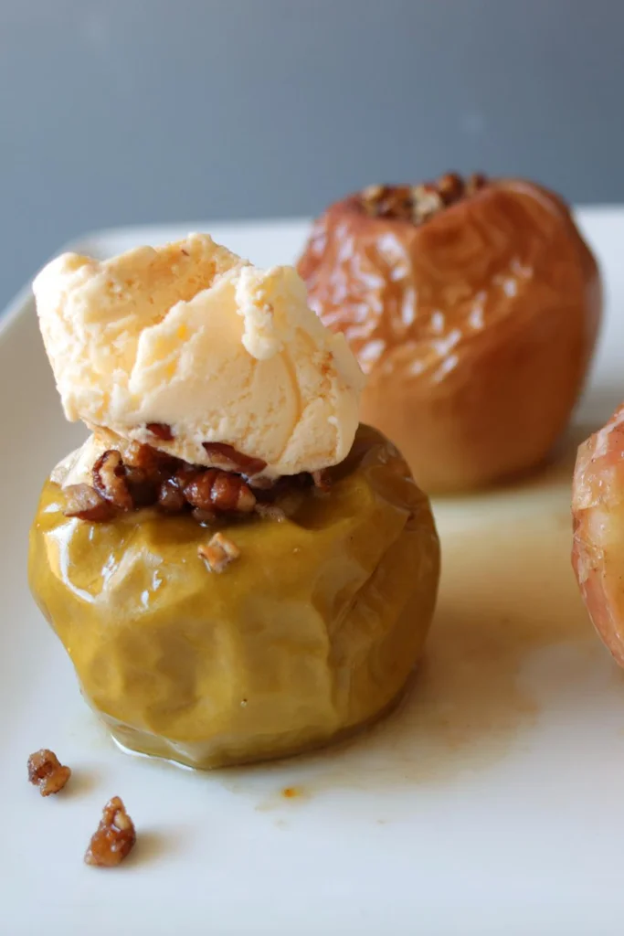 Baked apples on a white plate.