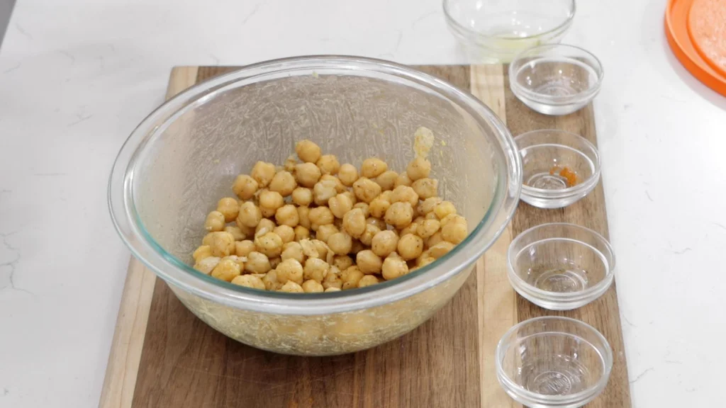 Seasoned chickpeas in a medium glass bowl.