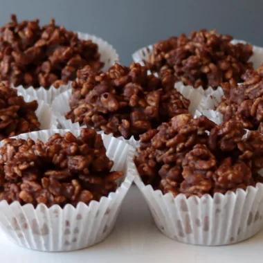Several homemade chocolate crackles on a white plate