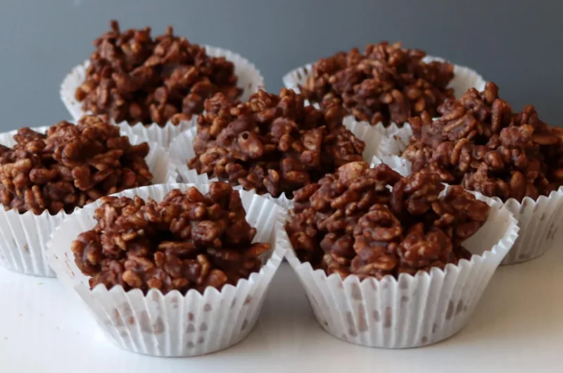 Several homemade chocolate crackles on a white plate