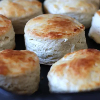 Several easy homemade buttermilk biscuits in a cast iron skillet.