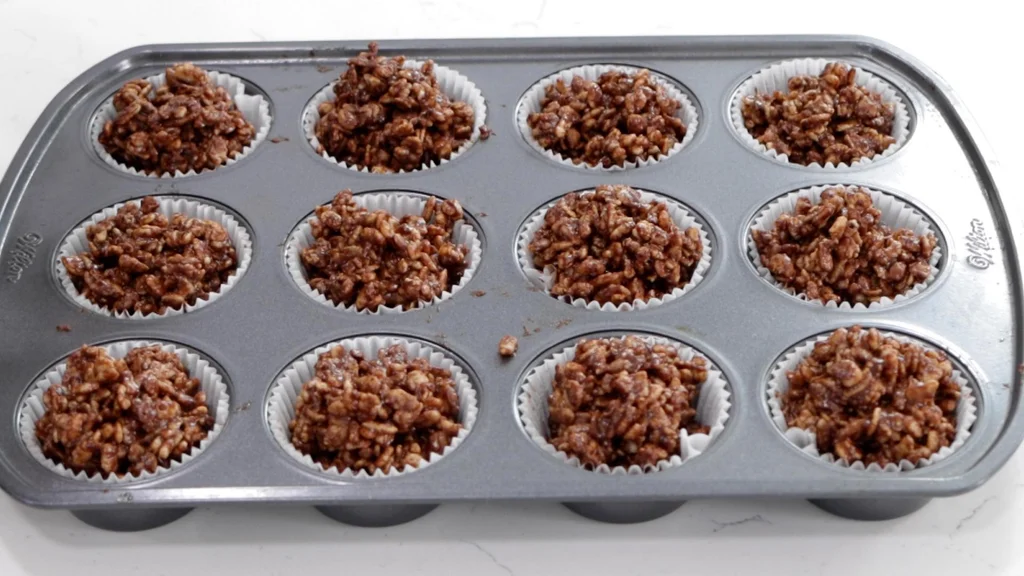Chocolate crackles in a muffin pan ready to chill