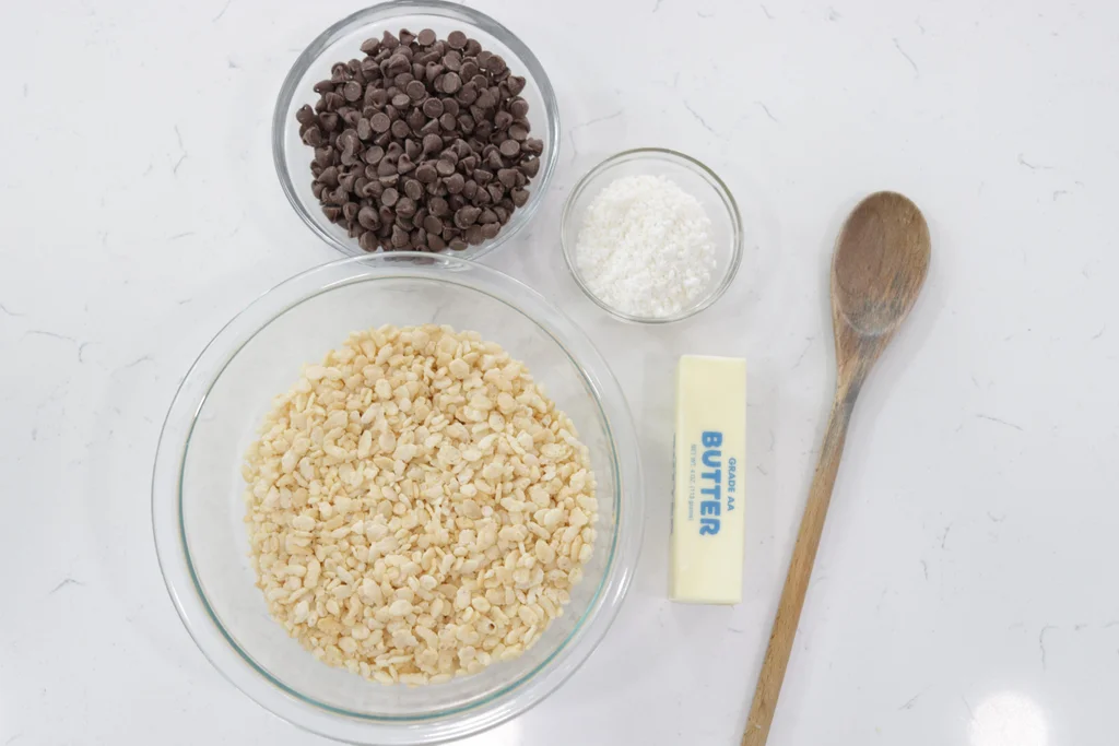 Rice Krispies, coconut, and butter on a counter.