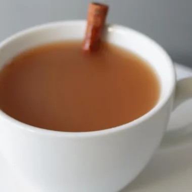 White mug full of homemade apple cider.