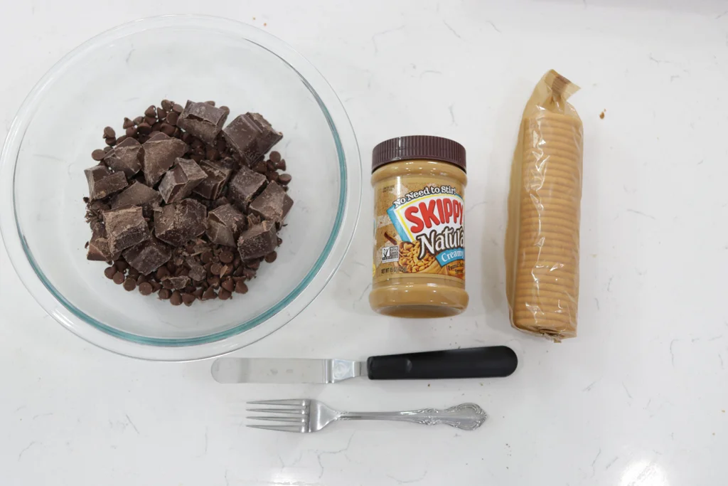 Chocolate, peanut butter, and Ritz crackers on a white plate.