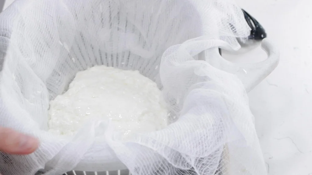 mozzarella cheese curds in a cheesecloth 