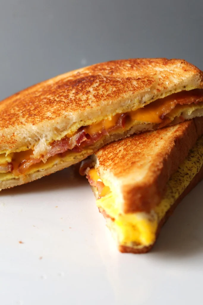 Sliced in half bacon, egg, and cheese sandwich. 