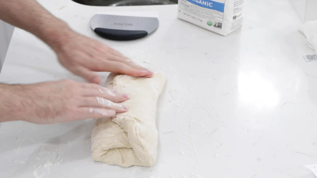Folding dough like an envelope.