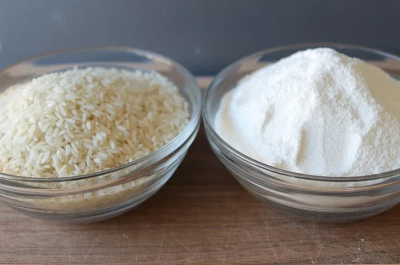 Bowl of homemade rice flour next to a bowl of rice.