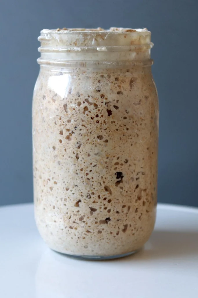 Mason jar filled with homemade sourdough starter.
