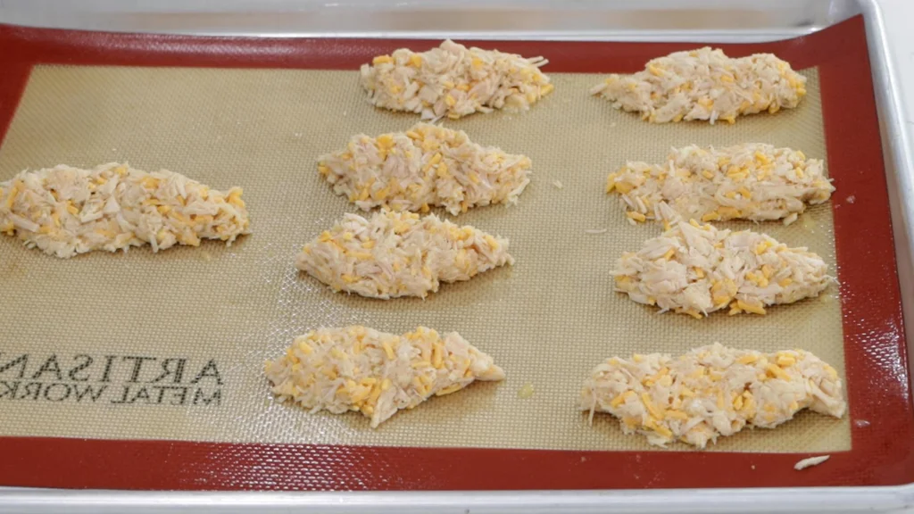 Chicken fingers ready to be baked.