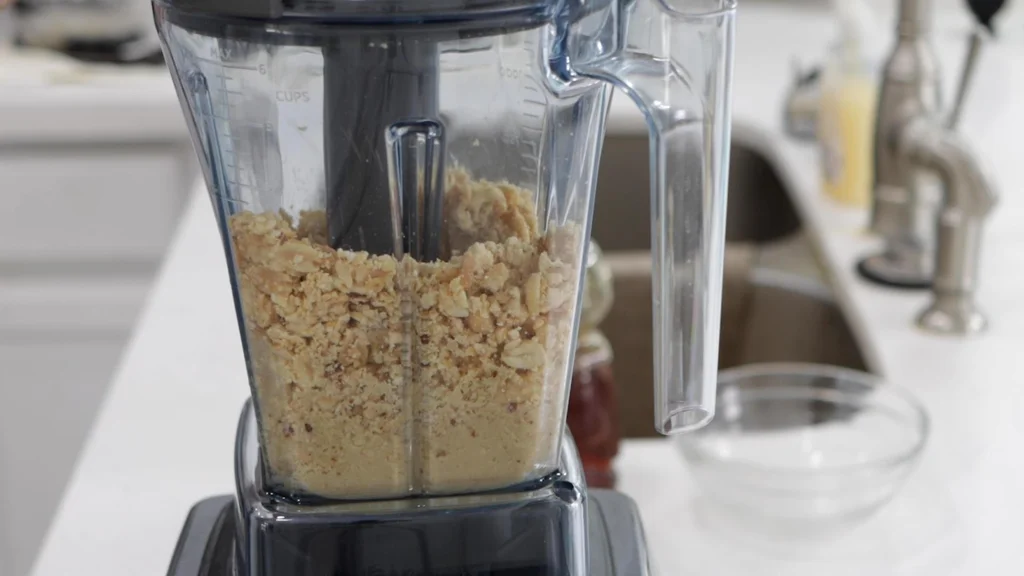 Peanuts and other ingredients blending in a Vitamix blender.