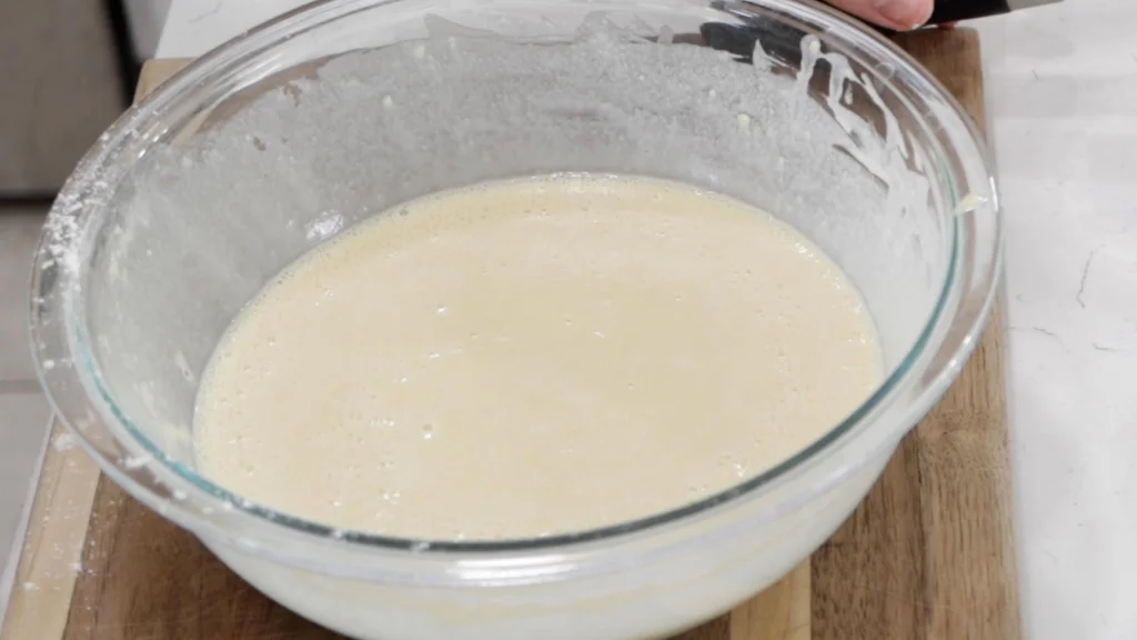 Finished gluten-free crepe batter in a glass bowl.