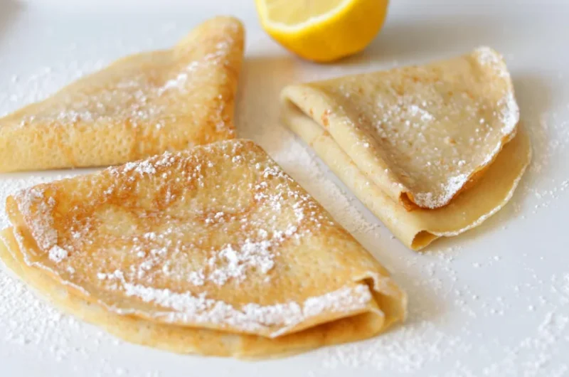 Gluten free crepes on a white plate.