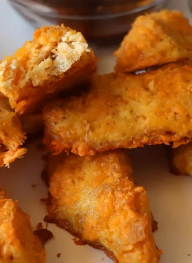 Homemade chicken fingers on a white plate.