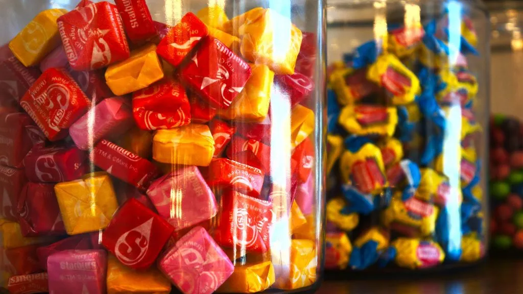 Bowl of Starbursts on a candy counter.