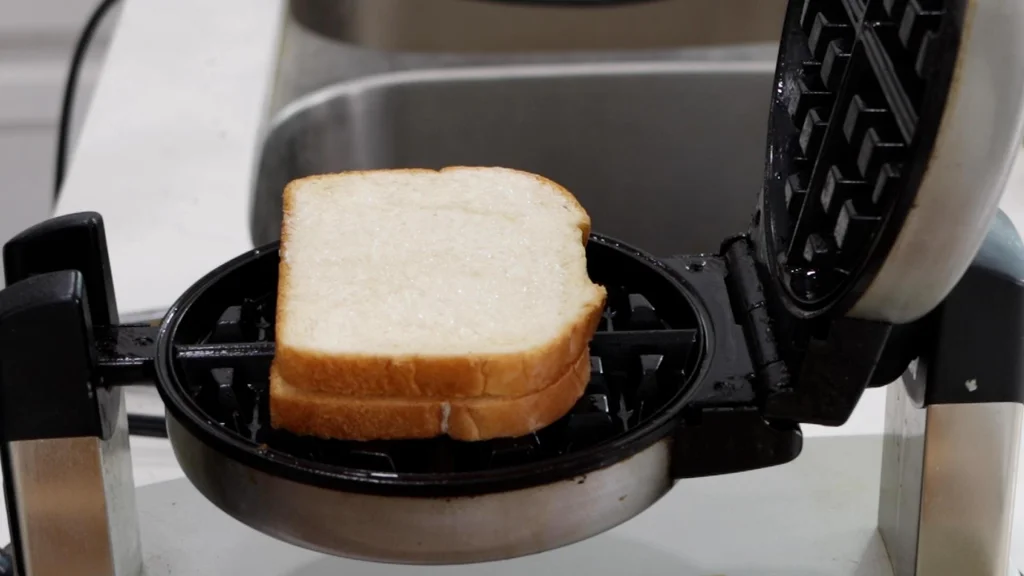 Grilled cheese sandwich ready to be cooked in a waffle iron.