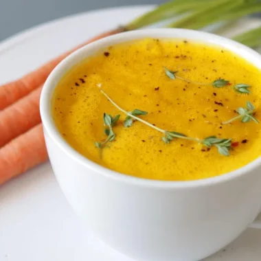 White mug filled with homemade carrot soup