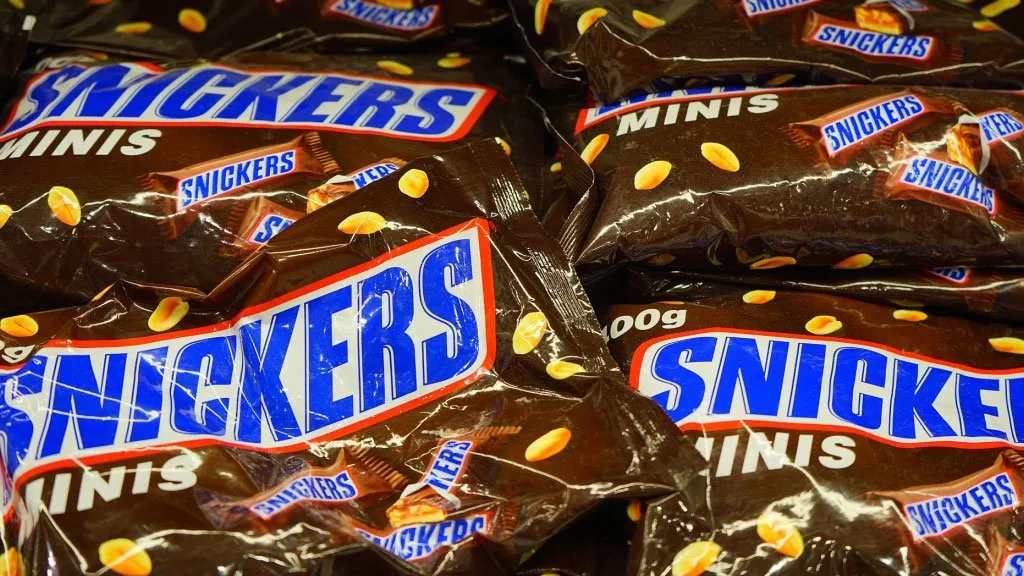 Candy Bags of Snickers the most popular candy in America in a Pile