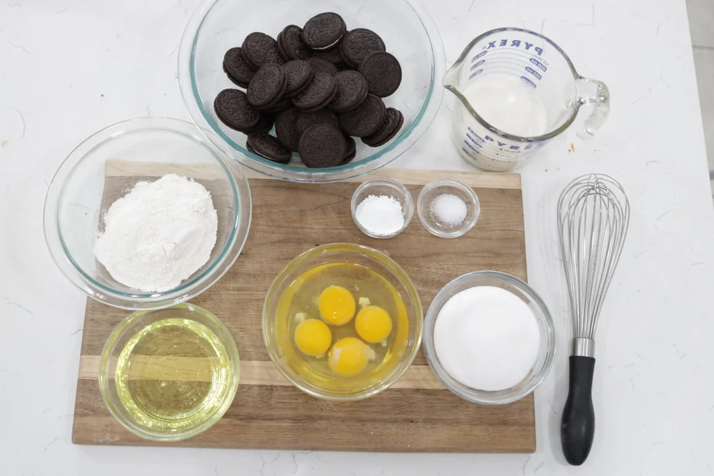 Several ingredients and Oreos on a wooden cutting board. Several ingredients and Oreos on a wooden cutting board.