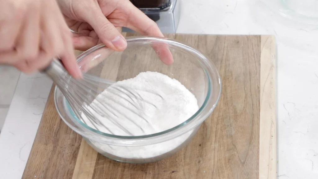 Hand whisking flour, salt, and baking powder in a small bowl. Hand whisking flour, salt, and baking powder in a small bowl.