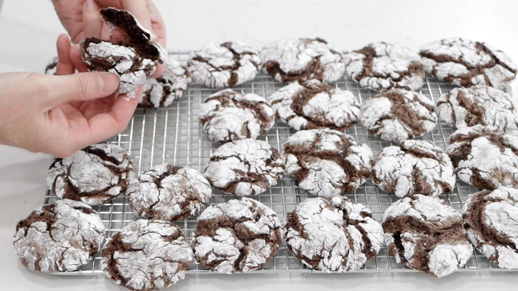 Several baked Cool Whip cookies on a wire rack. Several baked Cool Whip cookies on a wire rack.