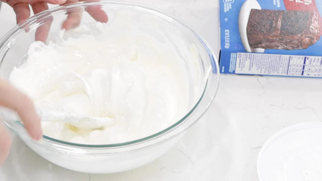 Large bowl with Cool Whip and an egg mixed together. Large bowl with Cool Whip and an egg mixed together.