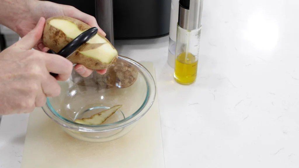 Hand peeling potatoes. Hand peeling potatoes.