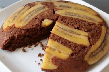 Chocolate banana upside down cake on a white plate.