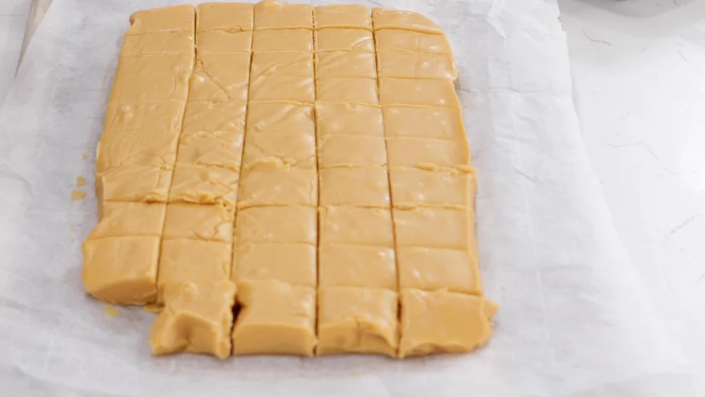 Finished homemade butterscotch fudge sliced into little squares. Finished homemade butterscotch fudge sliced into little squares.