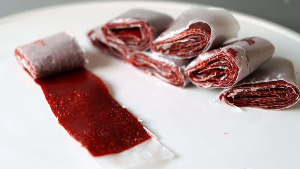 Finished strawberry fruit rollups sitting on a white plate. Finished strawberry fruit rollups sitting on a white plate.