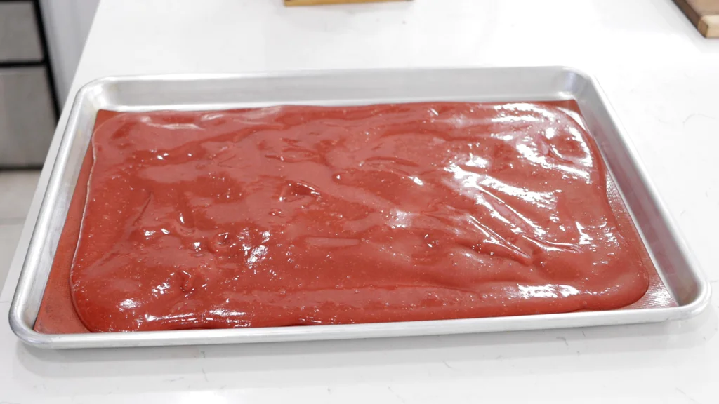 Undried strawberry fruit leather on a sheet pan. Undried strawberry fruit leather on a sheet pan.