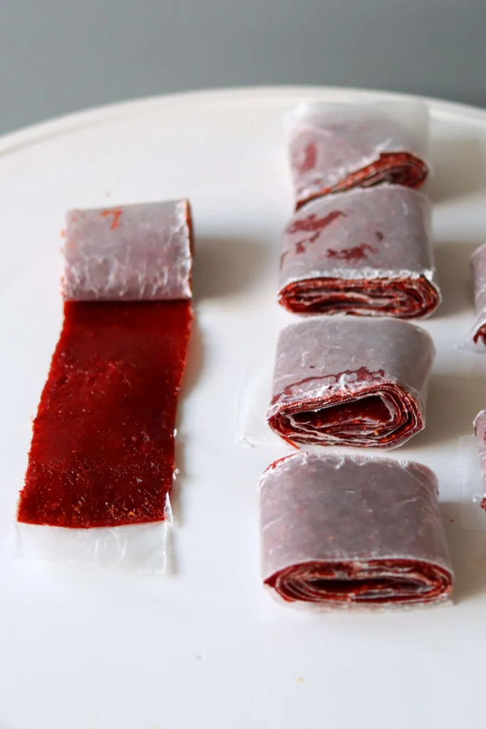 Homemade strawberry fruit rollups on a white plate. Homemade strawberry fruit rollups on a white plate.