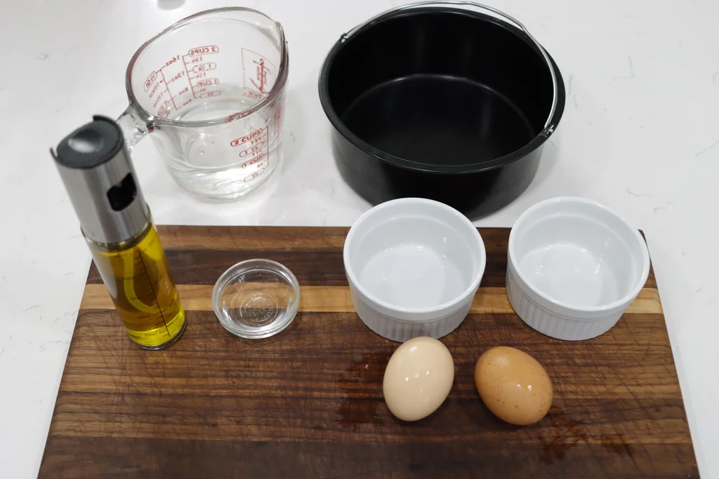 a few ramekins and eggs on a wooden cutting board. a few ramekins and eggs on a wooden cutting board.