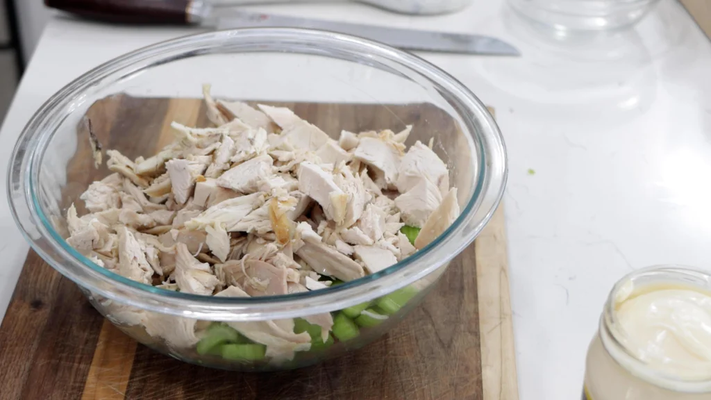 Bowl with chopped celery, sliced red grapes, and chopped chicken. Bowl with chopped celery, sliced red grapes, and chopped chicken.