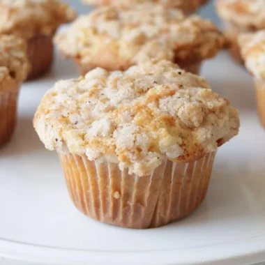 White plate with several homemade apple muffins