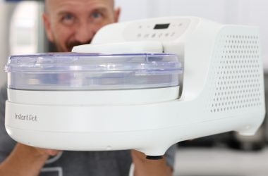 Hand holding an Instant Pot Instant Chill ice cream maker.