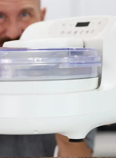 Hand holding an Instant Pot Instant Chill ice cream maker.